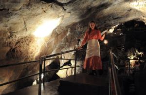 Woman holding lantern inside Crystal Cave