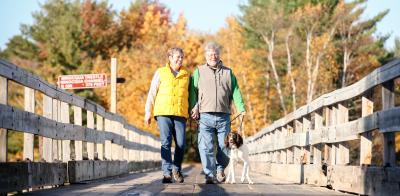 Couple hiking on the Bearskin Trestle with dog