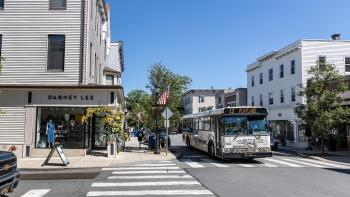 A Bee-Line Bus pass through the town of Rye where the streets are lined with shops and restaurants.