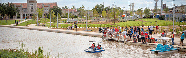 Two people on pedal boats at Scissortail Park