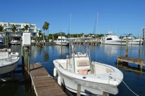Small white boat next to a dock at Cape Haze Marina in Englewood, FL