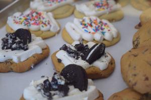 Freshly decorated cookies in the display window of a cookie and ice cream shop.