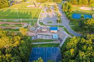 An aerial view of an atheltic complex with basketball, soccer, BMX, and soccer fields.