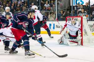 Columbus Blue Jackets player taking shot on goal