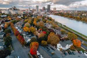 An image of the City of Rochester f5rom above surrounded by autumn leaves
