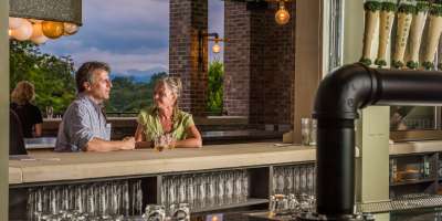 A couple enjoys the beautiful views from Green Man Brewing in Asheville, NC