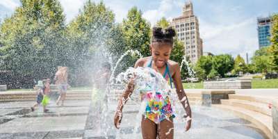 Girl playing in fountain at Splashveille park in Asheville