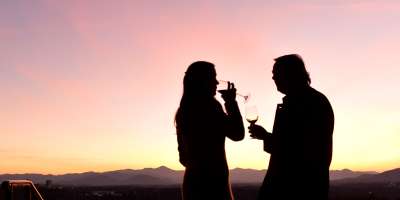 Couple drinking wine on Sunset Terrace at The Omni Grove Park Inn