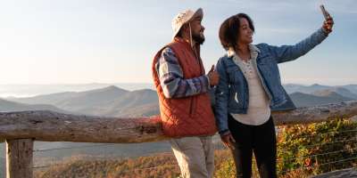 Two visitors take a selfie on the Blue Ridge Parkway near Asheville, NC