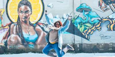 Jumping for joy in front of the Beyonce mural in Asheville's River Arts District