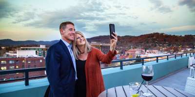 Couple Taking Selfie Photo from Rooftop Lounge in Downtown Asheville