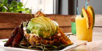 Close-up image of food and tropical drink at Salsa's