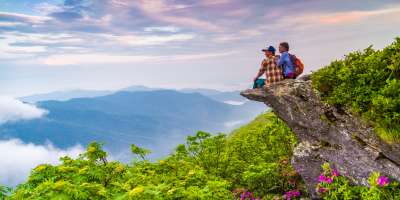 Hiker Couple at Craggy Pinnacle at Sunrise