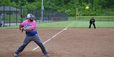 A batter takes a swing in a softball tourney