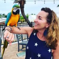 Woman With A Parrot On Her Arm In Panama City Beach
