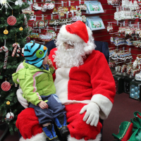 Santa sitting in chair at Khols Stony Hill Tree Farm