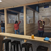 Picture of people at the Blue Moose doing the Axe Throwing Activity