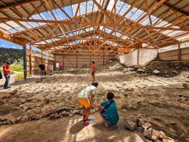 Two children admiring the dig site at the Wyoming Dinosaur Center.