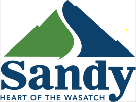 Green and blue mountain peak logo with the words Sandy Heart of the wasatch