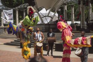 Two people walking on stilts at Goombay Festival in Asheville