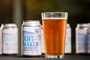 Close up of a can of Art Maker Pale Ale beer poured into a pint glass