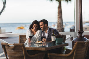 Couple enjoying happy hour on patio at Pavilion Hotel on Catalina Island