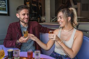 Couple drinking a flight of beer at Grand Illusion