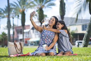 Smiling mother and daughter posing for a selfie in Daytona Beach