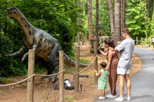 A young family at Cumberland County's Sweet Valley Ranch enjoying the Dino World Trail.