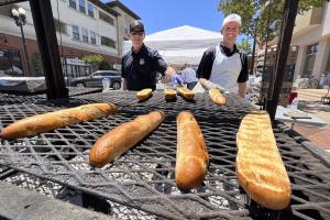 Men grilling garlic bread