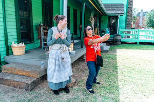 Nash Farm employee poses with a guest as they take a selfie