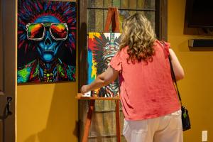 Woman looking at artwork at the Downtown Armory
