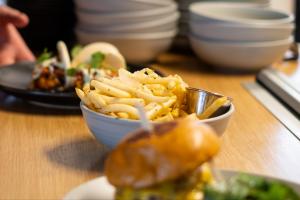 Fries with burgers in the background