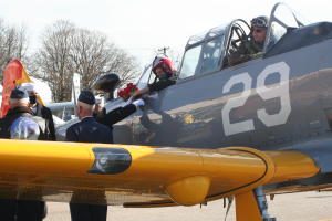 Navy Cadets deliver roses to a vintage AT-6 Texan Warbird at AAM