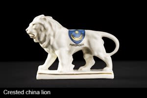 A china lion with the Portsmouth star and crescent on its body with the word Portsmouth underneath