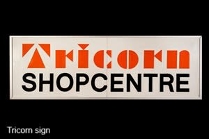 Sign for the Tricorn Shopcentre on a black background.