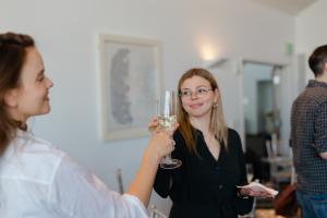 Two people toasting champagne glasses.