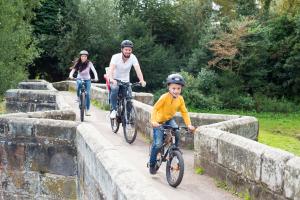 family bike ride across historic bridge