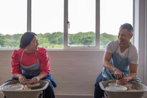 couple having fun throwing a pot