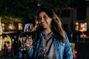 Woman dining on patio with tapas and wine