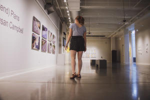 A woman looks at works of art on display in the Foundry Art Centre in St. Charles, MO