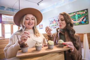Two women sharing four cups of ice cream at Hoodoo Ice Cream - Covington - Kevin Garrett