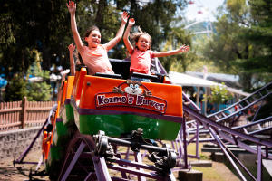 Children riding Kozmo’s Kurves at Knoebels Amusement Resort, a kid-friendly family attraction in the Susquehanna River Valley, PA.