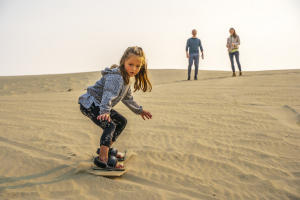 A child learns to sand board at the Killpecker Sand Dunes in southwest Wyoming