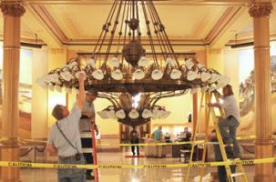 Changing light bulbs in rotunda chandelier Kansas Statehouse