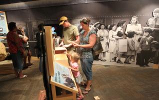 Family browsing exhibit at Heart Mountain Interpretive Center