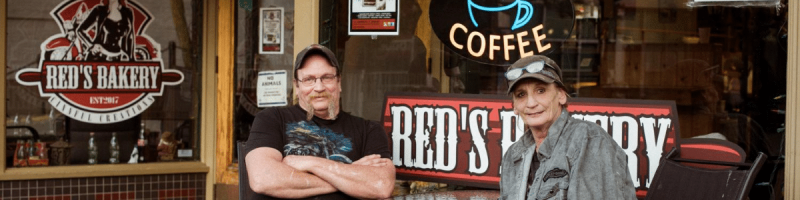 couple sitting outside Red's Bakery