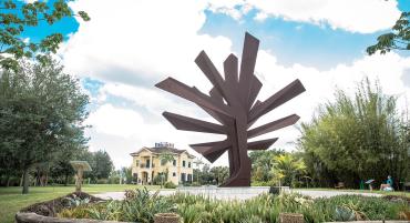 "Steel Palm" sculpture and Central Building at Peace River Botanical & Sculpture Gardens in Punta Gorda