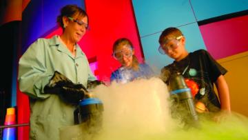 Kids watch a science experiment at the MOST in Syracuse, NY