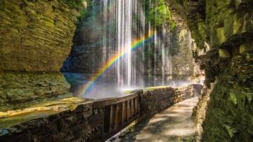 A rainbow seen through a waterfall at Watkins Glen State Park